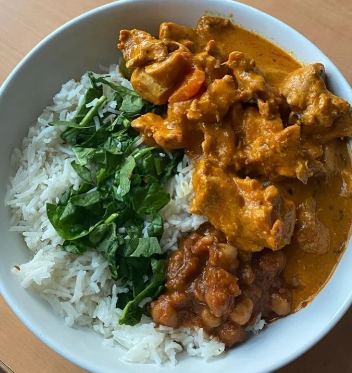 Chicken curry and chana over basmati rice with fresh spinach