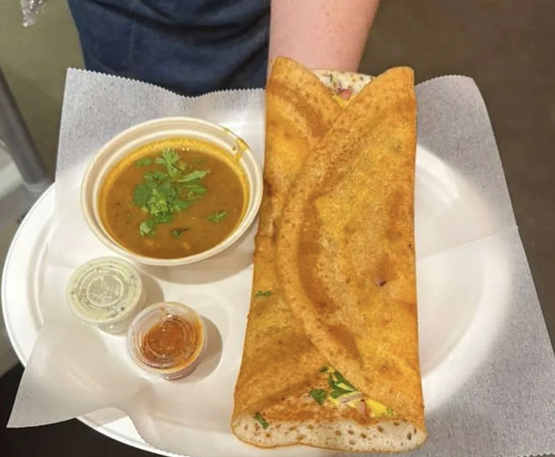 Dosa served with sambar and chutneys